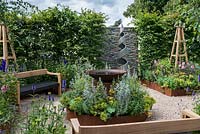 An Arts and Crafts inspired garden room with water feature, raised corten steel beds and hand crafted benches. A Summer Retreat designed by Laura Arison and Amanda Waring. Hampton court flower show 2016