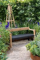An Arts and Crafts inspired garden room with hand crafted bench and obelisk surrounded by perennials. A Summer Retreat designed by Laura Arison and Amanda Waring. Hampton court flower show 2016