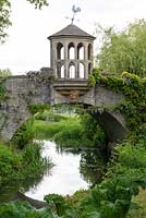 The stone bridge and Watch Tower that spans the water garden at Dunsborough Park.