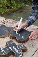 Use a white paint pen to write a label on the Oak slices