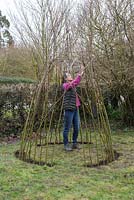 Bend the Willow sticks over one another and tie together with twine to form the Teepee