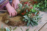 Adding Variegated Ivy to the wreath