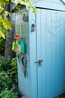 Blue painted shed with storage for tools 