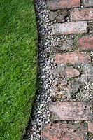 Brick and gravel path by lawn