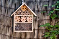 Insect bug box or hotel for overwintering bugs attached to cane fencing
