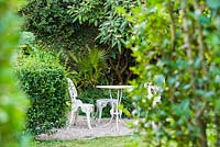 Sheltered seating area inside tall privet hedges that give protection from the prevailing winds.