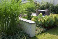 View on the terrace, border with Euphorbia characias and Miscanthus sinensis.
