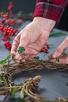 Weaving the Ivy in and out of the wreath frame - creating a berry wreath