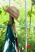 Wicker hat of gardener in a greenhouse