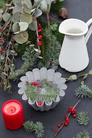 Materials required for constructing a frozen Pine candle bowl. Pine foliage, Eucalyptus and berries of Ilex verticillata
