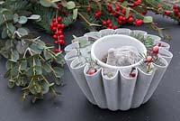 A frozen Jelly mould containing Pine foliage, Eucalyptus and Ilex verticillata berries