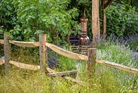 Stile and rustic wooden fencing. Hampton Court Flower Show 2016. 'The Lavender Garden' designed by Paula Napper, Sara Warren, Donna King