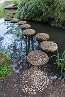 Stepping stone pathway linking two of the islands. Beloved by children who visit. Each stepping stone is inscribed with the Yin-Yang symbol in pebble mosaic.