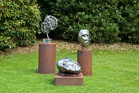 Metal head sculptures by Hilary Cartmel displayed on the croquet lawn at Bolham Manor, Nottinghamshire