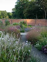 Late afternoon sun in the walled garden with summer planting.