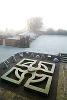 Morning fog over box parterre and garden viewed from tower window