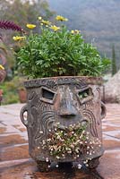 Terracotta pot with face design on tiled patio - Lake Atitlan Hotel, Guatemala