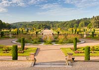 A view over the formal Upper Flower Garden, down over the Italian Garden at Trentham Gardens, Staffordshire - designed by Tom Stuart-Smith. Planting in the Upper Flower Garden includes Pelargoniums, Begonias, Stipa gigantea and fastigate Irish yews