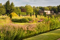 A view across the Italian Garden at Trentham Gardens, Staffordshire - designed by Tom Stuart-Smith. Pictured just after dawn in summer, planting includes Veronicastrum, clipped Portuguese laurels, fastigate Irish yews, Geraniums and Salvias