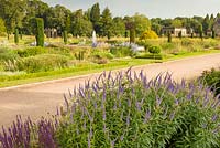 An early morning view over the borders and fountains in the Italian Garden at Trentham Gardens, Staffordshire - designed by Tom Stuart-Smith. Foreground planting includes Veronicastrums and Salvias