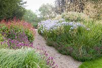 Dawn in the Floral Labyrinth at Trentham Gardens, Staffordshire, designed by Piet Oudolf. Photographed in summer planting includes Stipa gigantea, Agastaches, Persicaria and Phlox paniculata