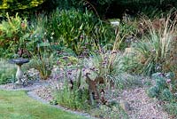 Little Ash Garden, Fenny Bridge, Devon. Birdbath in gravel garden with Verbena bonariense and metal sculptures