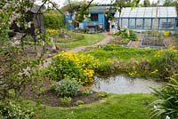 Urban garden with wildlife pond, chicken coop, greenhouse and potting shed.