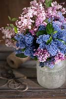 Ceanothus and Syringa 'Red Pixie' bouquet in a glass vase