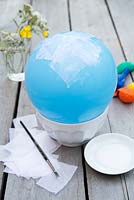 Making paper lanterns - Blow up balloon to desired size and balance on bowl 