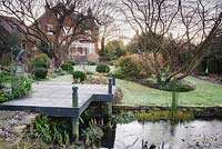 Frosty deck beside the pond in the back garden at Windy Ridge, Little Wenlock, Shropshire, UK