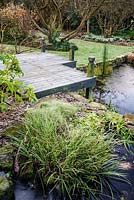 Frosty deck beside the pond in the back garden at Windy Ridge, Little Wenlock, Shropshire, UK