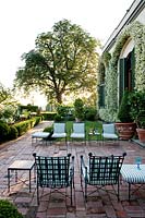 Terrace with chairs. La Limonaia Garden. Designed by Arabella Lennox Boyd. Fiesole. Florence. Italy