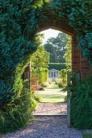 A gateway connects a renovated, pre-existing area to a newly created walled garden with a summerhouse, in a modern Cheshire country garden. It was designed by Louise Harrison-Holland
