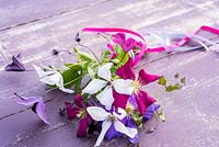 Clematis flowers tied into posy with ribbons