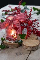 Decorated festive lantern with Berries and ribbon