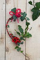 Hanging natural Christmas decoration with Berries and Holly