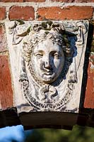 Close up of ornate plaque. Bridge End Garden, Saffron Walden, Essex, UK. January.