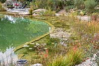 The shallow water zone contains water plants that keep the water clean and is separated from the deeper swimming zone