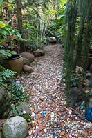 Pathway lined with broken pots and ceramics. Sculptor and ceramicist Marcia Donahue's garden in Berkeley, California.