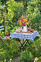 Floral and harvest display in the summer vegetable garden.
