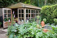 Gardeners' hut in a vegetable garden with views across Rhubarb and raised beds in a Tom Hoblyn designed garden at Heatherbrae