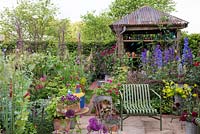 The Anneka Rice Colour Cutting Garden - Cut flower garden with seating area. shed with galvanised roof -  RHS Chelsea Flower Show 2017