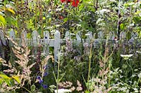 White picket fence through wildflower planting - RHS Hampton Court Flower Show 2015.
