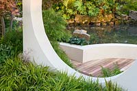 Detail of Japanese style garden framed with 'Moongate' window, with sunken circular area with Hakonechloa macra, ferns, Acer palmatum and Gunnera manicata - 'At One With...A Meditation Garden' - Howle Hill Nursery, RHS Malvern Spring Festival 2017