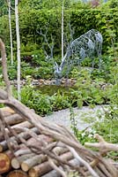 Metal stag drinking from a pond with Betula utilis - Buckfast Abbey Millennium Garden, RHS Malvern Spring Festival 2017 