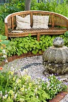 Wooden Bench with cushions underplanted with Epimedium and Hosta - Spa Garden - I follow the Waters and the Wind, RHS Malvern Spring Festival 2017 