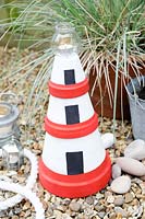 Making a Garden Lighthouse Lantern with Terracotta Pots - add a small lantern or jam jar on to the top with a tealight