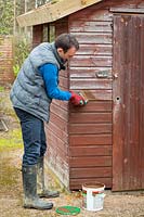 Treating a wooden shed with preservative