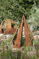 Conical corroded steel structure, housing edible planting in a garden of drought-tolerant cacti and perennials in the Cactus Direct:2101 Garden at Tatton RHS Flower Show 2017
