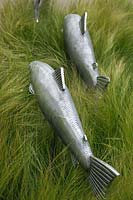 Metal fish in border of Stipa tennuissima, Gaze Burvill stand, RHS Chelsea 2012, May.